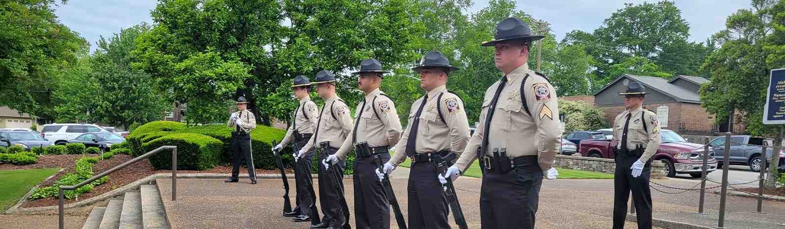 The sheriff's office deputies standing above a staircase howling rifles.