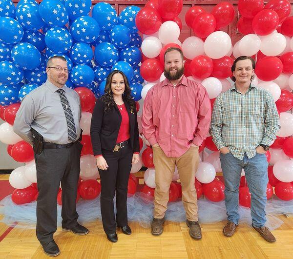 Sheriff Personnel in front of Red White & Blue Background