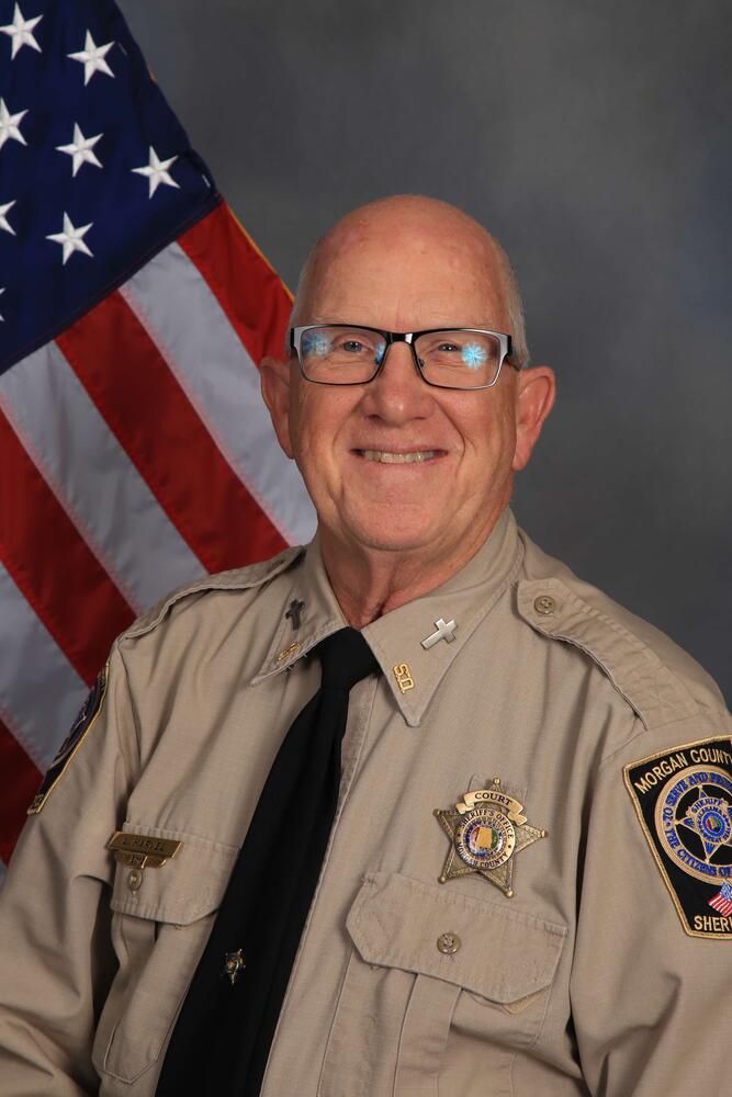 Deputy in uniform by flag