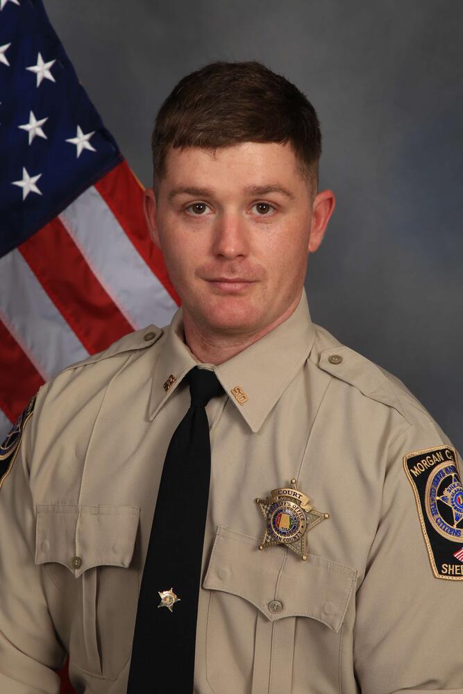 Deputy in uniform by flag