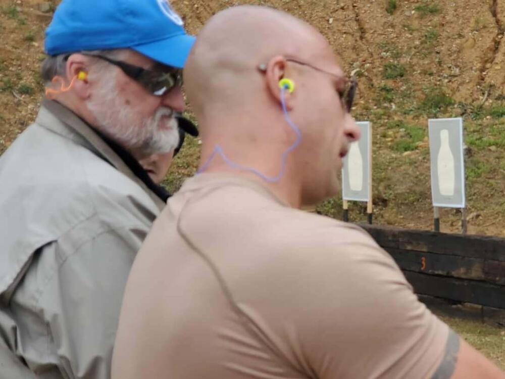 Deputy training citizen on firing range