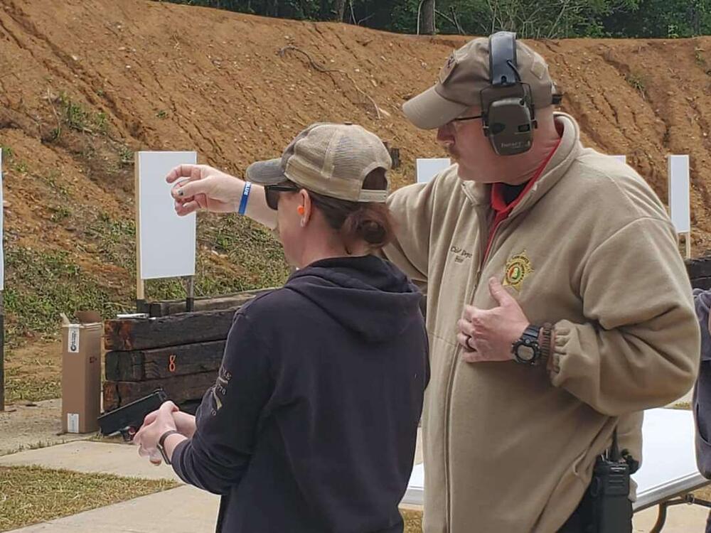 Deputy training citizen on firing range