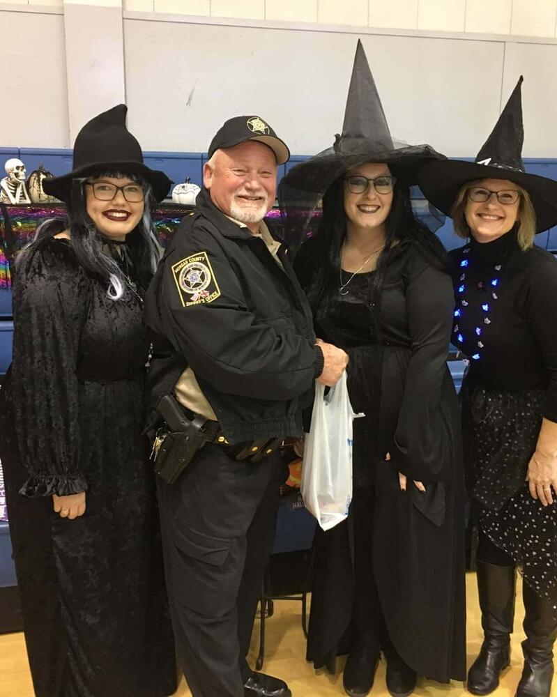 SRO in uniform with three teachers dressed as witches