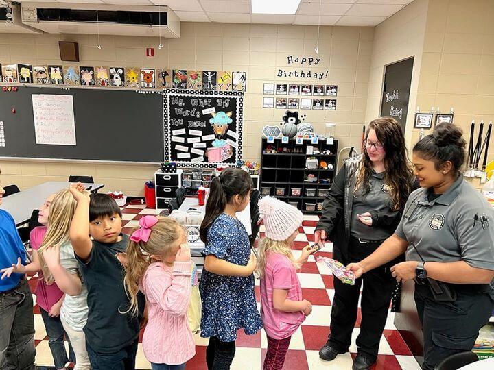 Correction Officer reading to elementary students