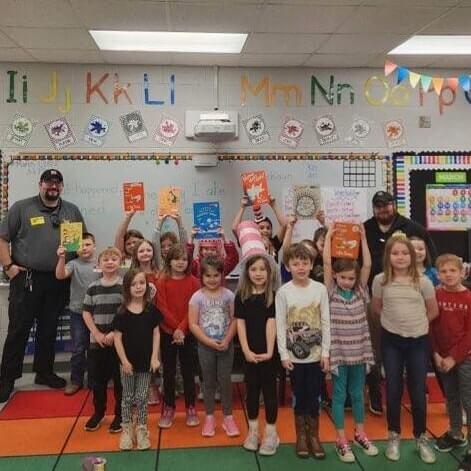 Correction Officer reading to elementary students