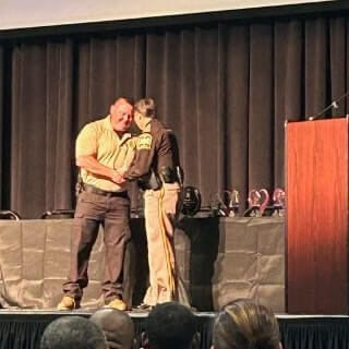 Deputy on stage accepting award