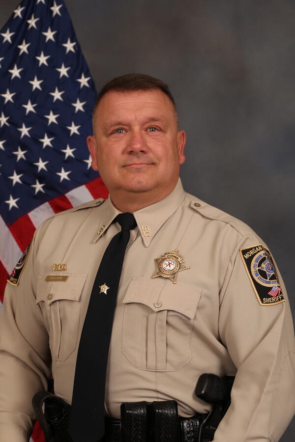 Sgt Chris Dillard in Uniform in front of flag