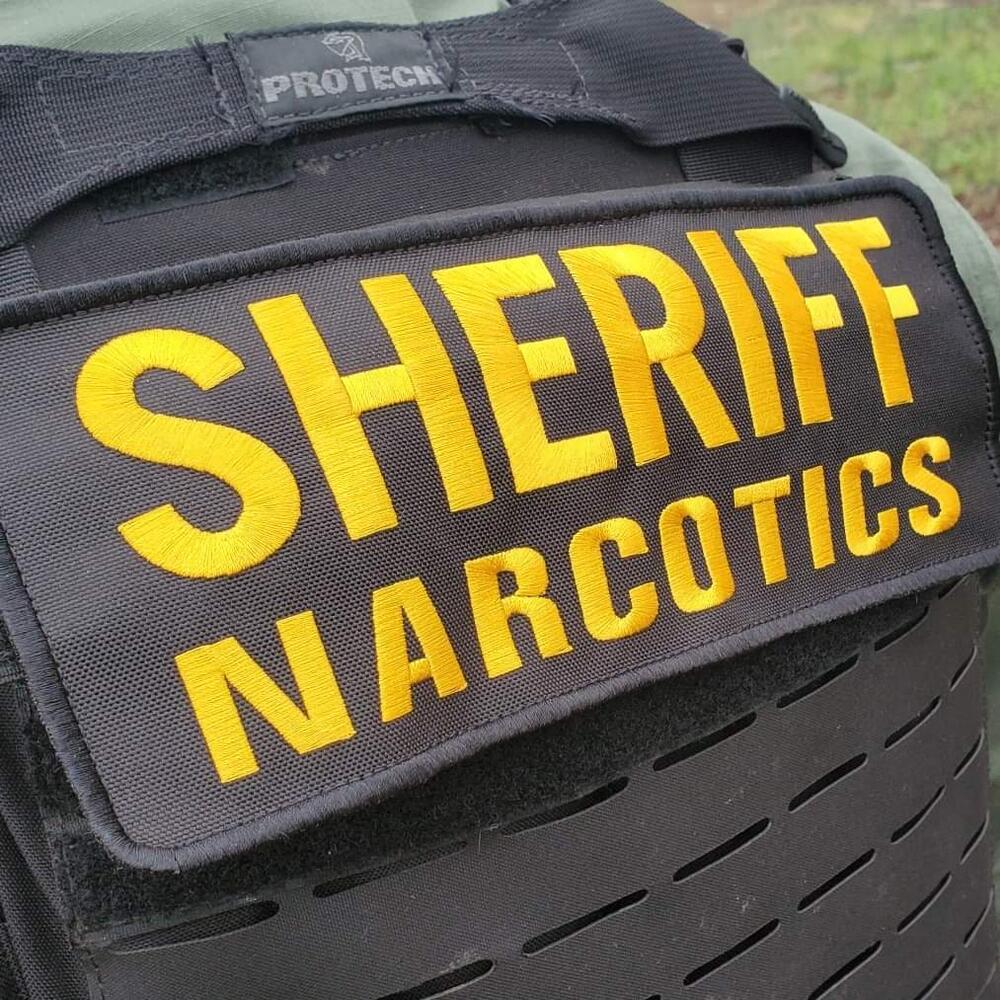 Sheriff Narcotics on back of vest