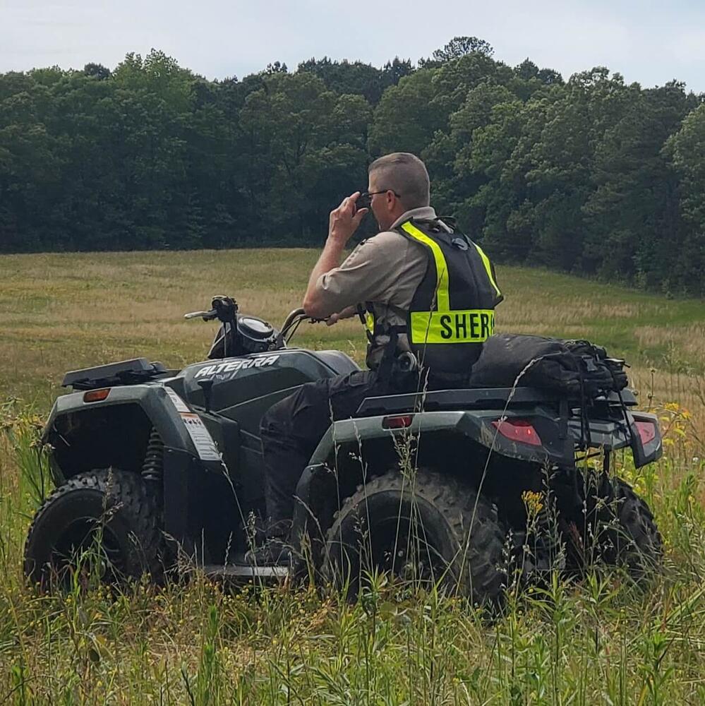 Investigator on 4-wheeler in field