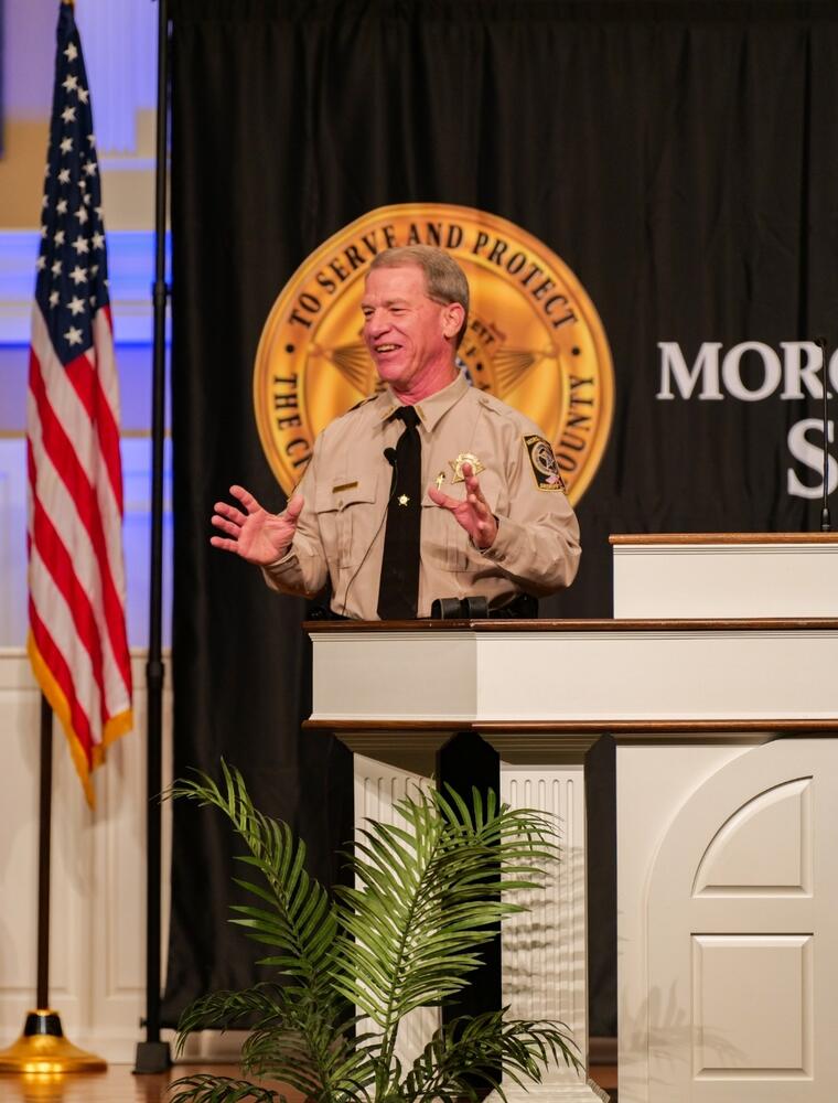 Sheriff Puckett standing on stage near the podium