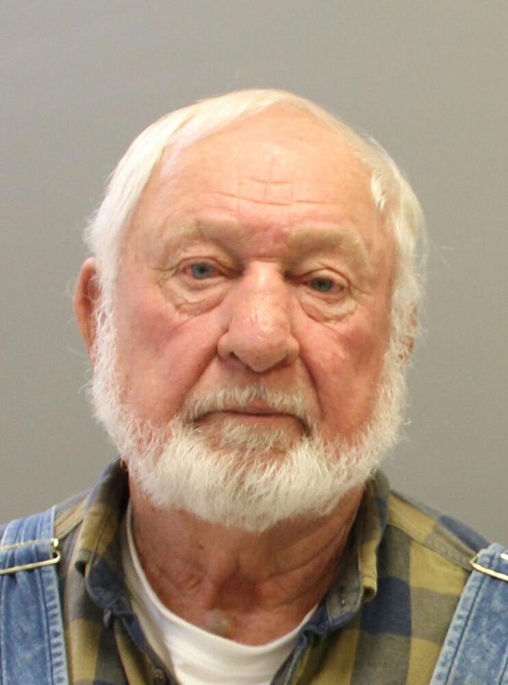 Older Male facing camera in mugshot photo